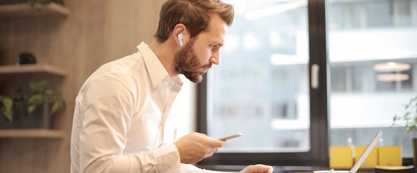 man wear wireless earbuds working home